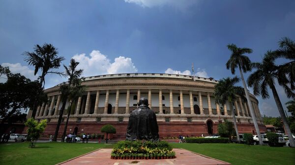A statue of Mahatma Gandhi sits in front of the old Parliament House on the opening day of the monsoon session of the Indian parliament - Sputnik भारत
