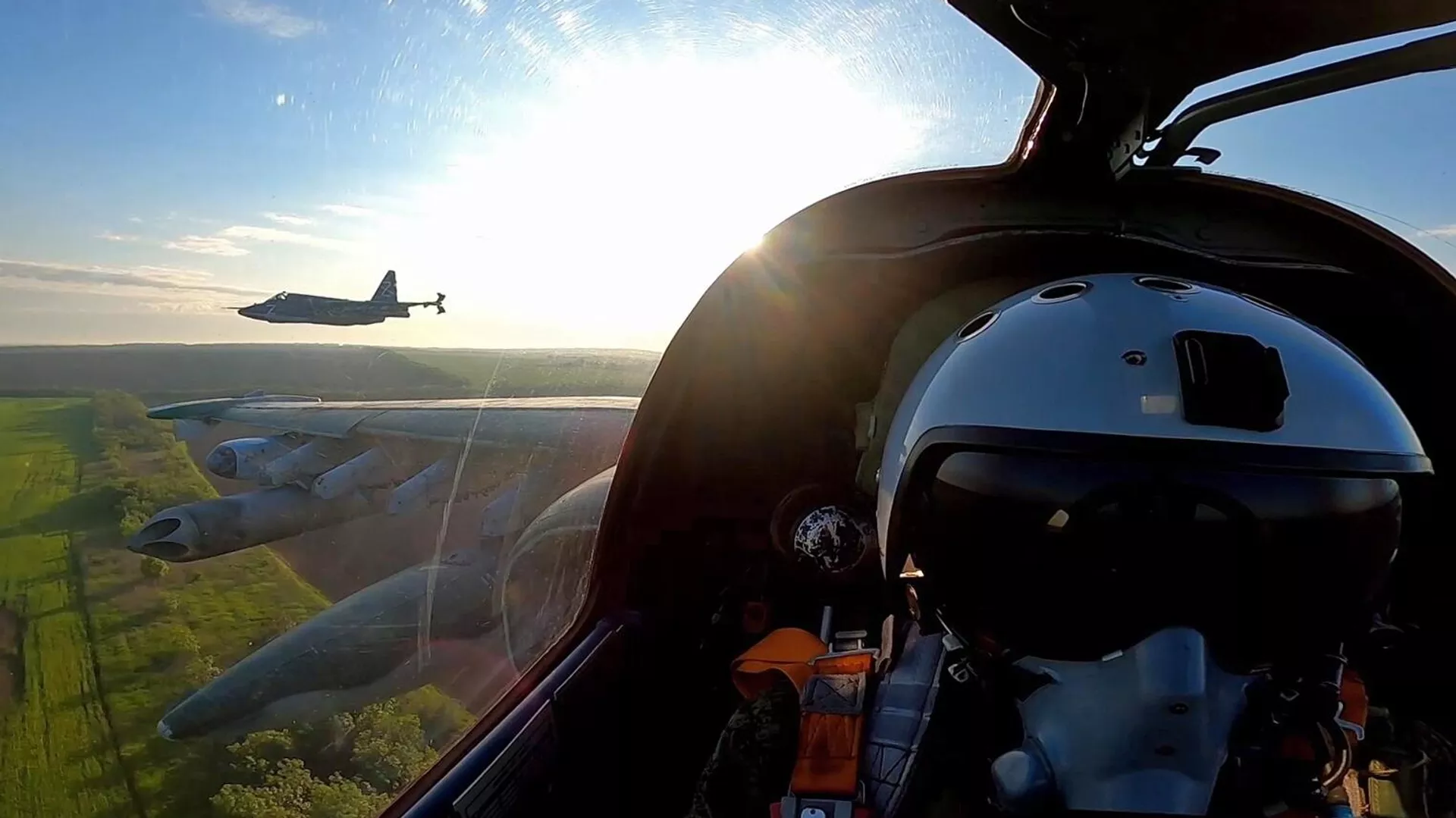 In this handout photo released by the Russian Defence Ministry, a pilot of a Russian Sukhoi Su-25 fighter jet is seen inside a cabin during a flight in the course of Russia's military operation in Ukraine, at the unknown location