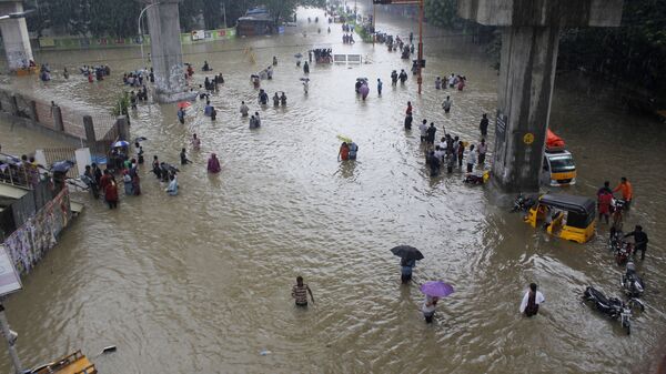 People wade through a flooded road in Chennai, Tamil Nadu, India, Wednesday, Dec. 2, 2015 - Sputnik India