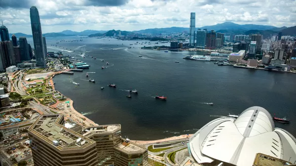 Fishing boats sail through Victoria harbour in Hong Kong on July 1, 2019 - Sputnik India