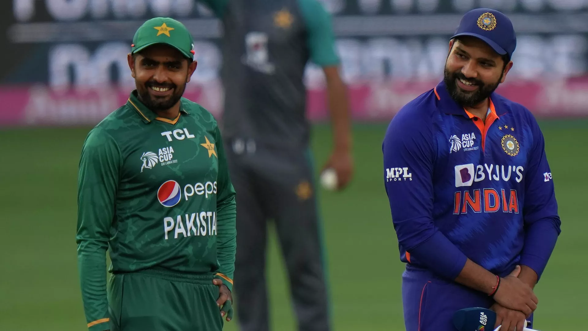 Pakistan's captain Babar Azam, left, and India's captain Rohit Sharma smile as they wait for the toss ahead of the T20 cricket match of Asia Cup between India and Pakistan, in Dubai, United Arab Emirates, Sunday, Sept. 4, 2022.