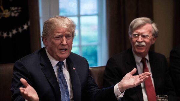 US President Donald Trump speaks during a meeting with senior military leaders at the White House in Washington, DC, on April 9, 2018. At right is new National Security Advisor John Bolton. (Photo by NICHOLAS KAMM / AFP) - Sputnik भारत