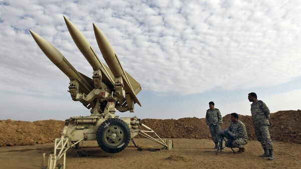 In this Nov. 13, 2012 file photo obtained from the Iranian Mehr News Agency, Iranian army members prepare missiles to be launched, during a maneuver, in an undisclosed location in Iran - Sputnik India