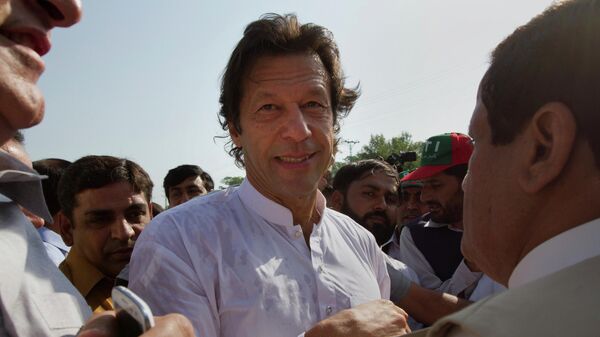Pakistan's ex-cricket star-turned-politician Imran Khan, center, is surrounded by his supporters as he arrives to lead what organizers are calling the peace march, in Islamabad, Pakistan, Saturday, Oct. 6, 2012. - Sputnik India