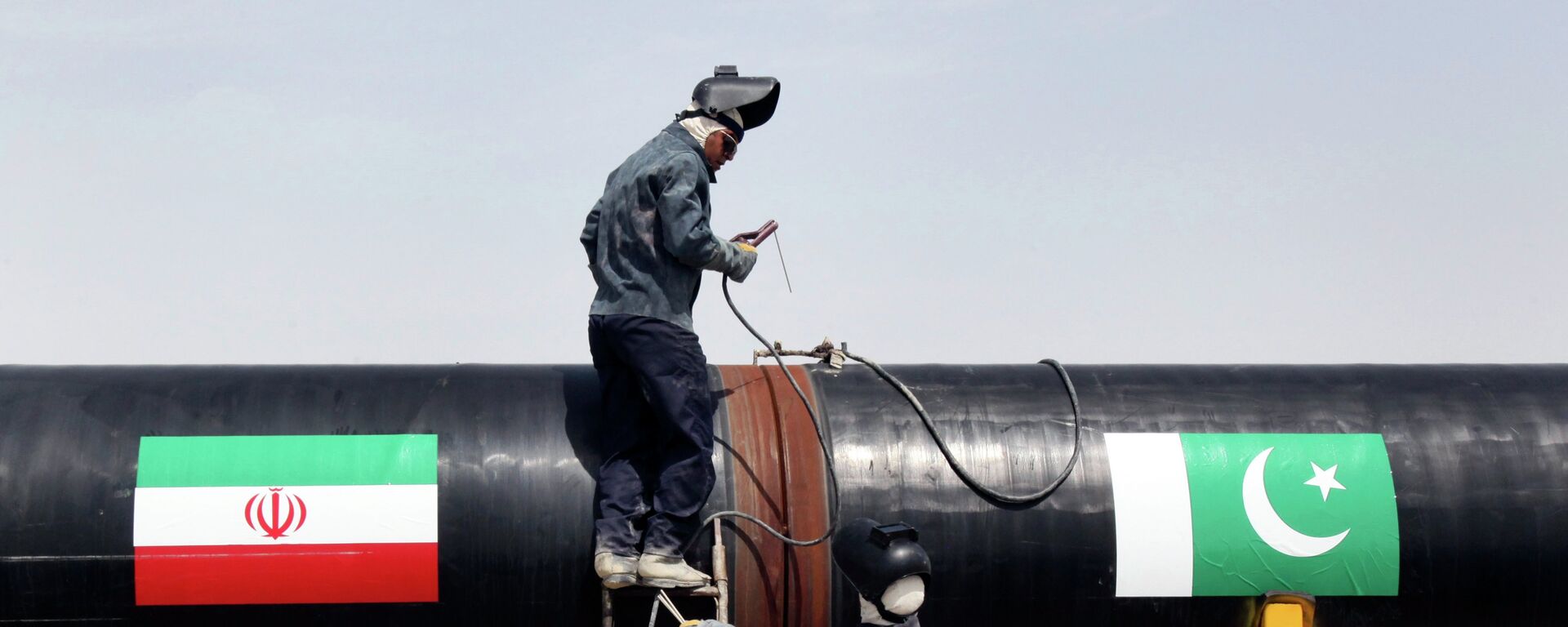 FILE - In this March 11, 2013 file photo, Iranian workers weld two gas pipes together at the start of construction on a pipeline to transfer natural gas from Iran to Pakistan, in Chabahar, southeastern Iran, near the Pakistani border - Sputnik India, 1920, 09.08.2023