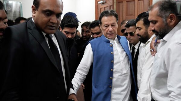 Pakistan's former Prime Minister Imran Khan arrives to sign documents as he submits surety bond over his bails in different cases at an office of Lahore High Court in Lahore, Pakistan - Sputnik भारत