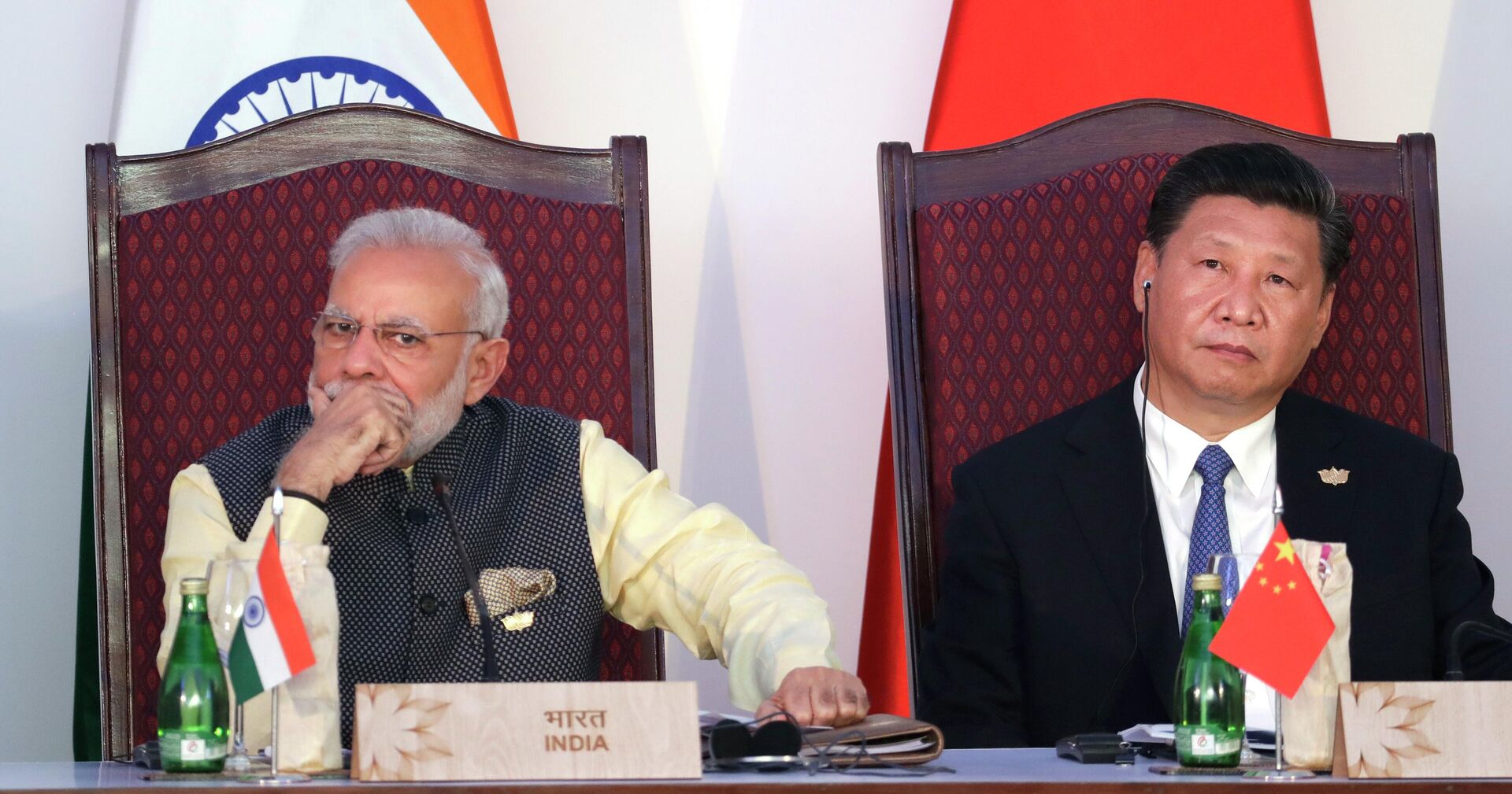  Indian Prime Minister Narendra Modi, left, and Chinese President Xi Jinping listen to a speech during the BRICS Leaders Meeting with the BRICS Business Council in Goa, India - Sputnik India, 1920, 09.08.2023