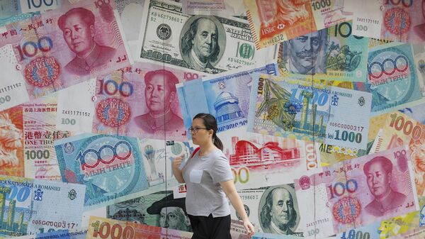 A woman walks by a money exchange shop decorated with banknotes of Chinese yuan and US dollars at Central, a business district in Hong Kong, Tuesday, Aug. 6, 2019. - Sputnik भारत