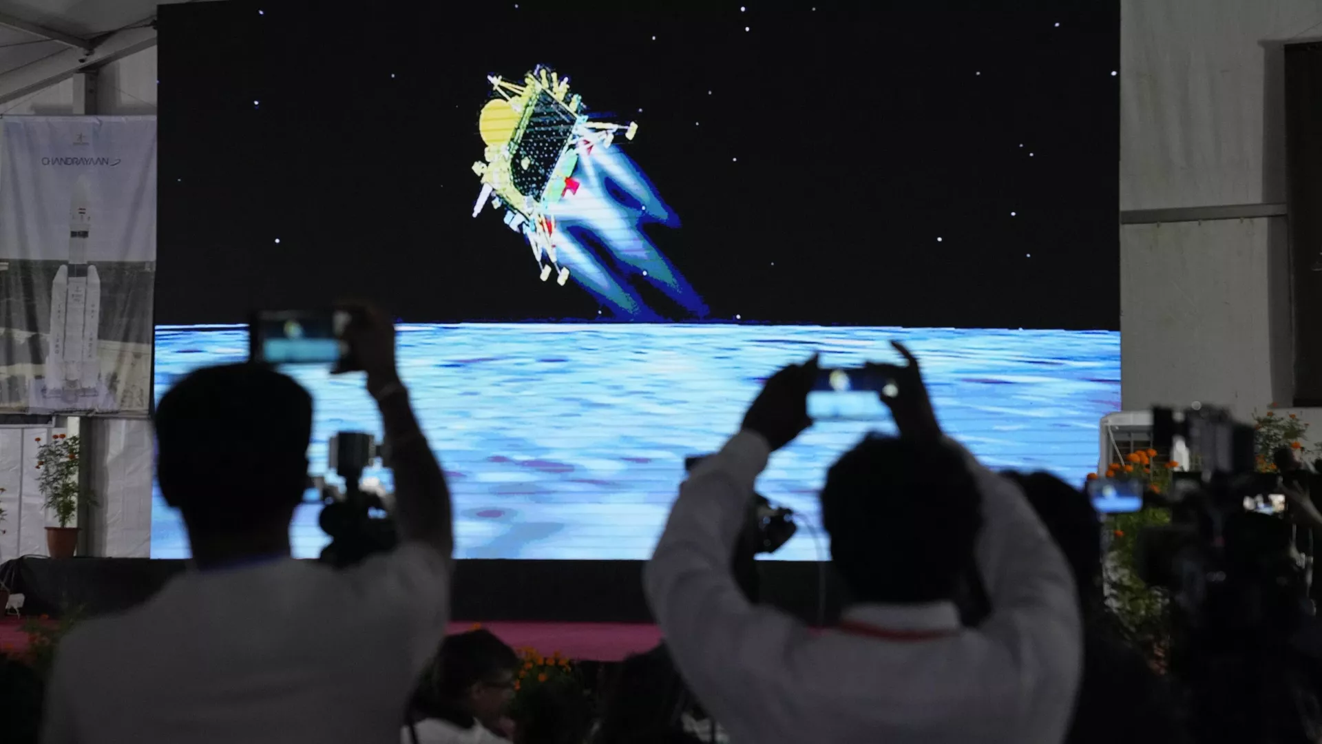 Journalists film the live telecast of spacecraft Chandrayaan-3 landing on the moon at ISRO's Telemetry, Tracking and Command Network facility in Bengaluru, India, Wednesday, Aug. 23, 2023.