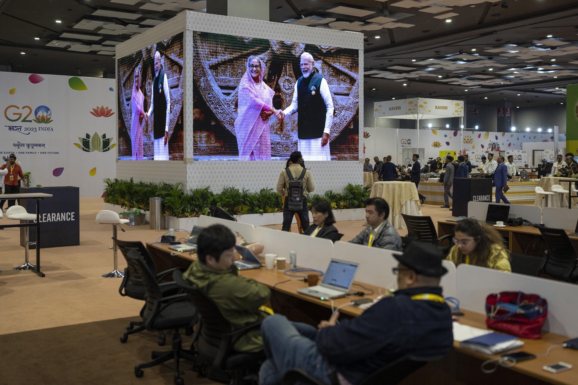 Journalists work at the international media centre as live pictures displayed on a big screen show Indian Prime Minister Narendra Modi welcomes Bangladesh Prime Minister Sheikh Hasina at Bharat Mandapam convention center for the G20 Summit in New Delhi, India, Saturday, Sept., 9, 2023.  - Sputnik India, 1920, 29.11.2023