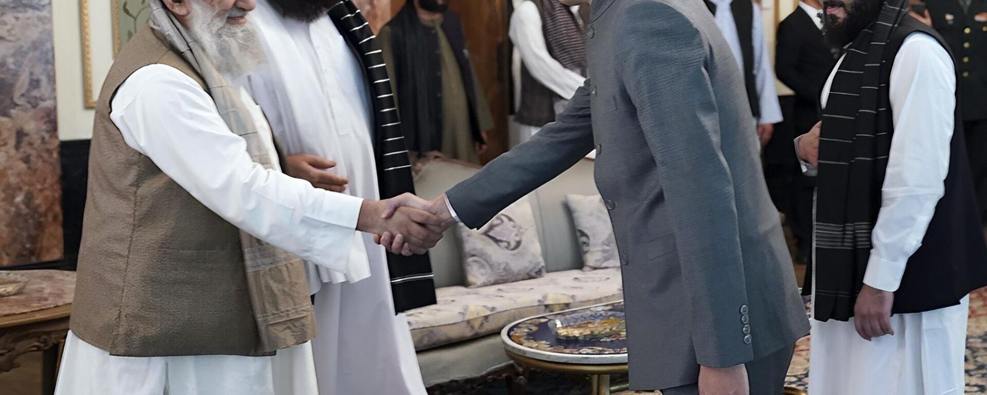In this handout photo released by Taliban Prime Minister Media Office, China's new ambassador to Afghanistan Zhao Sheng shakes hand with Taliban Prime Minister Mohammad Hasan Akhund, left, during the recognition ceremony at the Presidential Palace, in Kabul, Afghanistan, Wednesday, Sept. 13, 2023. - Sputnik India, 1920, 13.09.2023