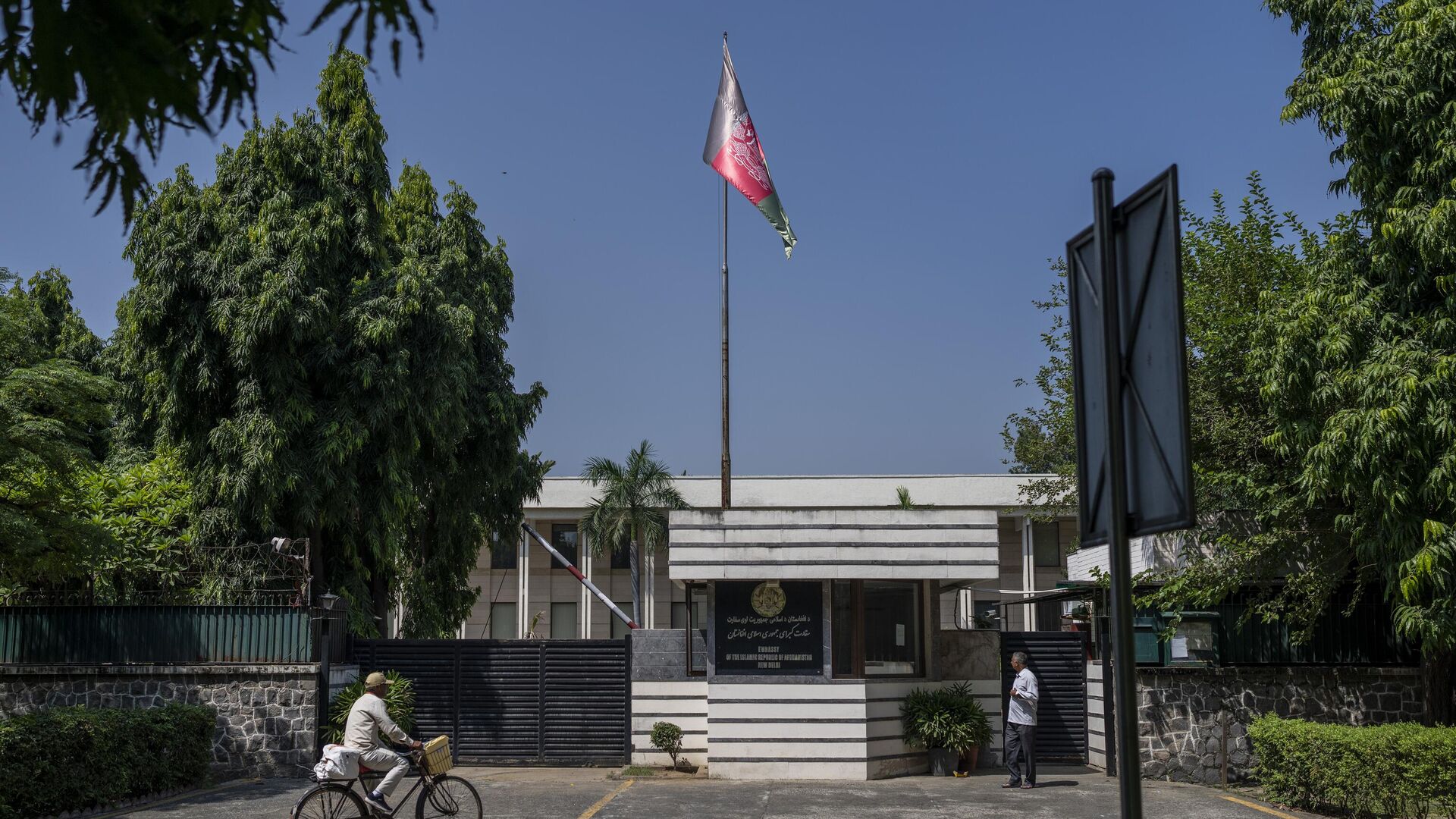 A cyclist pedals past the Afghan Embassy in New Delhi, India, Saturday, Sept. 30, 2023. India's External Affairs Ministry is examining a letter from the Afghan Embassy that says it plans to cease all operations in the Indian capital by Saturday, an official said Friday. India has not recognized the Taliban government which seized power in Afghanistan in August 2021. - Sputnik भारत, 1920, 01.12.2023