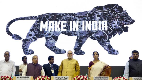 Indian Prime Minister Narendra Modi, center, unveils the logo of 'Make in India' initiative in New Delhi, India, Sept. 25, 2014. India on Thursday said it would ramp up its production of military equipment, including helicopters, tank engines, missiles and airborne early warning systems, to offset any potential shortfall from its main supplier Russia. - Sputnik India