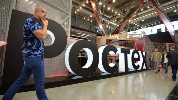 A visitor walks past Rostec's stand at the attends the Innoprom International Industrial Fair, in Yekaterinburg, Russia - Sputnik भारत