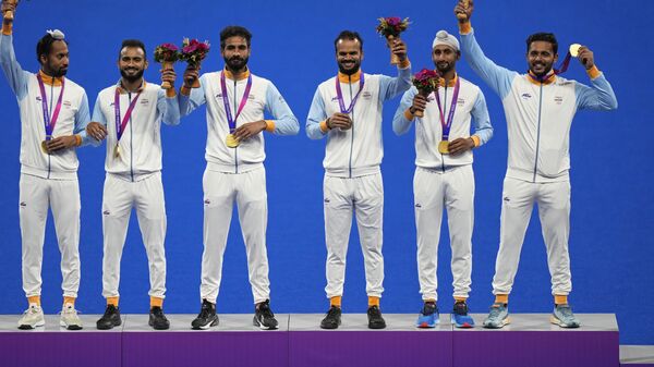 Gold medalist team India captain Harmanpreet Singh, right, and teammates celebrate on the podium during the awards ceremony of men's hockey at the 19th Asian Games in Hangzhou, China, Friday, Oct. 6, 2023. - Sputnik India