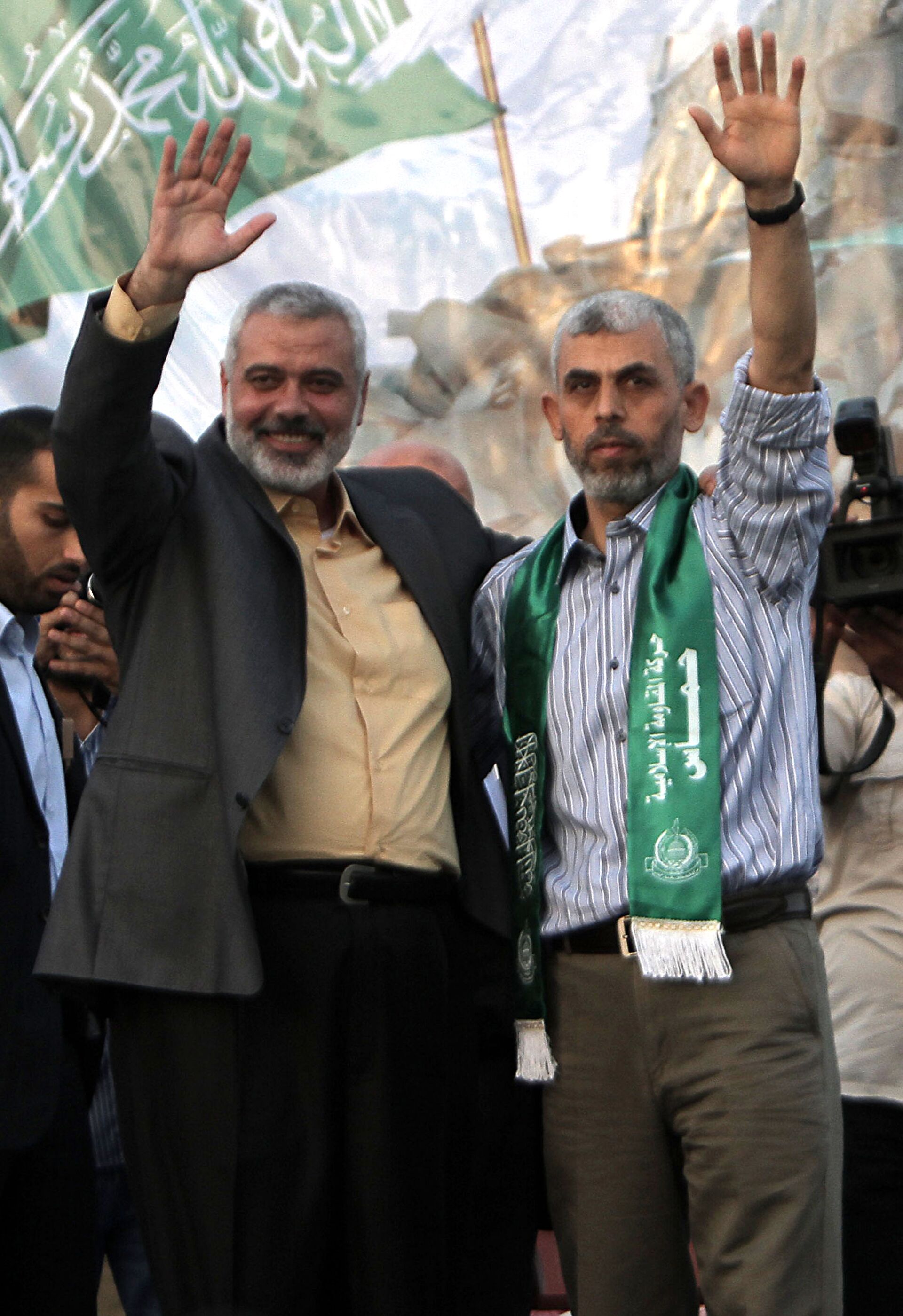 This file photo taken on October 21, 2011 shows then Hamas leader Ismail Haniya (L) and freed Palestinian prisoner Yahya Sinwar (R), a founder of Hamas' military wing, waving as supporters celebrate the release of hundreds of prisoners following a swap with captured Israeli soldier Gilad Shalit in Khan Yunis, southern Gaza Strip - Sputnik India, 1920, 09.10.2023