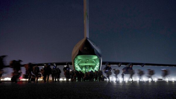 FILE - In this Aug. 30, 2021, file photo provided by the U.S. Air Force, soldiers, assigned to the 82nd Airborne Division, prepare to board a U.S. Air Force C-17 Globemaster III aircraft at Hamid Karzai International Airport in Kabul, Afghanistan. A State Department report says the department failed to do enough contingency planning before the collapse of the U.S.-backed government in Afghanistan. The review repeatedly blames the administration of former President Donald Trump for not doing enough planning or processing of visas after beginning the withdrawal.  - Sputnik India