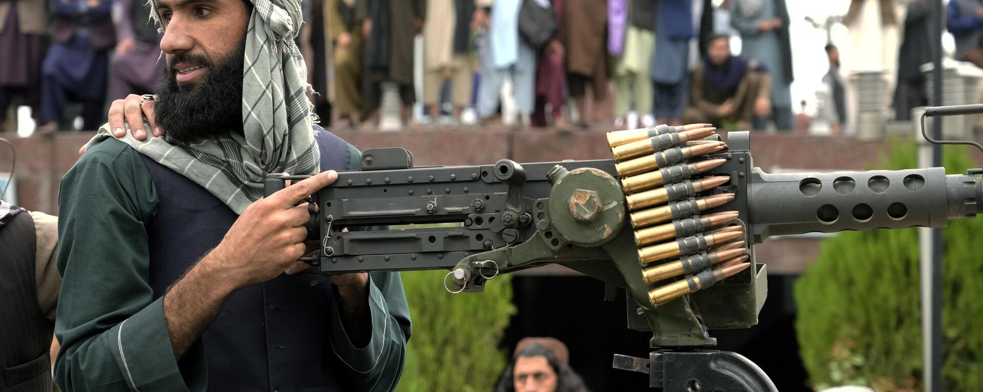 A Taliban fighter mans his weapon during celebrations one year after the Taliban seized the Afghan capital, Kabul, in front of the U.S. Embassy in Kabul, Afghanistan, Monday, Aug. 15, 2022.  - Sputnik भारत, 1920, 09.10.2023