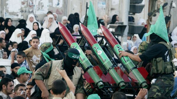 Masked Palestinian Hamas militants display their weapons during a parade in Gaza City. File photo. - Sputnik India