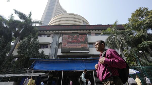 People walk past an electronic signage displaying news on federal budget at the Bombay Stock Exchange (BSE) building in Mumbai, India, Wednesday, Feb. 1, 2023. - Sputnik India