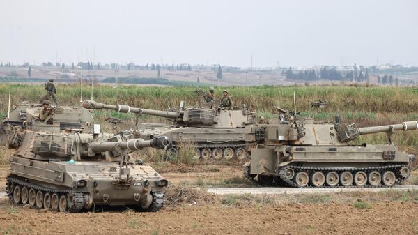 Israeli army soldiers are positioned with their armoured vehicles near the border with the Gaza Strip in southern Israel on October 9, 2023.  - Sputnik India