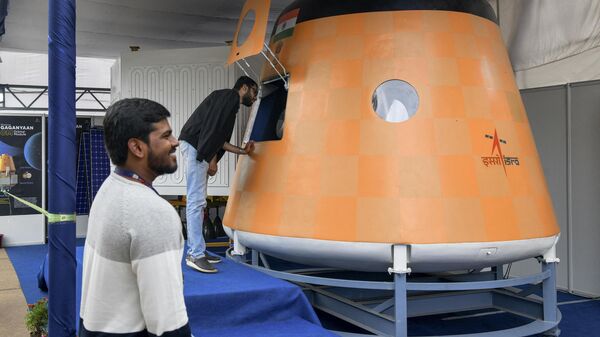 Visitors look at an actual scale model of “Gaganyaan Orbital Module”, India’s first manned space flight at the Human Space Flight Expo organised by the Indian Space Research Organisation (ISRO) at the Jawaharlal Nehru Planetarium in Bangalore on July 21, 2022. - Sputnik India