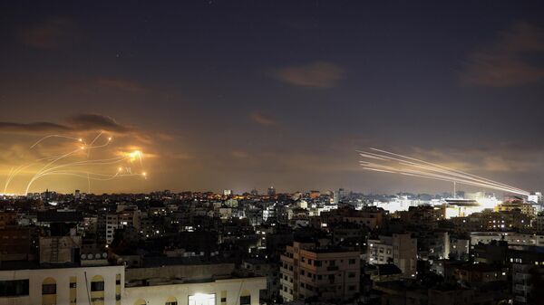 Rockets fired from the Gaza City (R) being intercepted by Israel's Iron Dome defence missile system (L) on October 10, 2023.  - Sputnik India