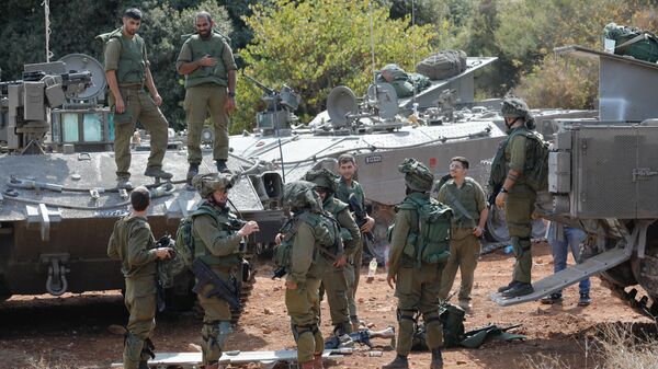 Israeli soldiers take position in northern Israel near the border with Lebanon on October 9, 2023.  - Sputnik India