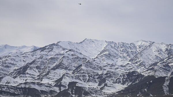 Indian army’s helicopter flies over snow covered mountains near Leh, the joint capital of the union territory of Ladakh on February 28, 2022.  - Sputnik भारत
