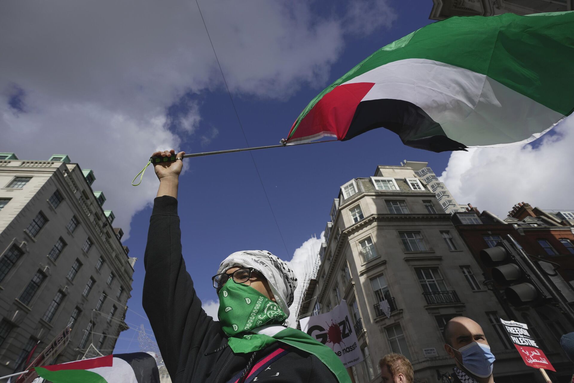 A man waves a Palestinian flag during a pro Palestinian demonstration in London, Saturday, Oct. 14, 2023, in support of Palestinians caught up in the war between Israel and Hamas. - Sputnik India, 1920, 29.11.2023