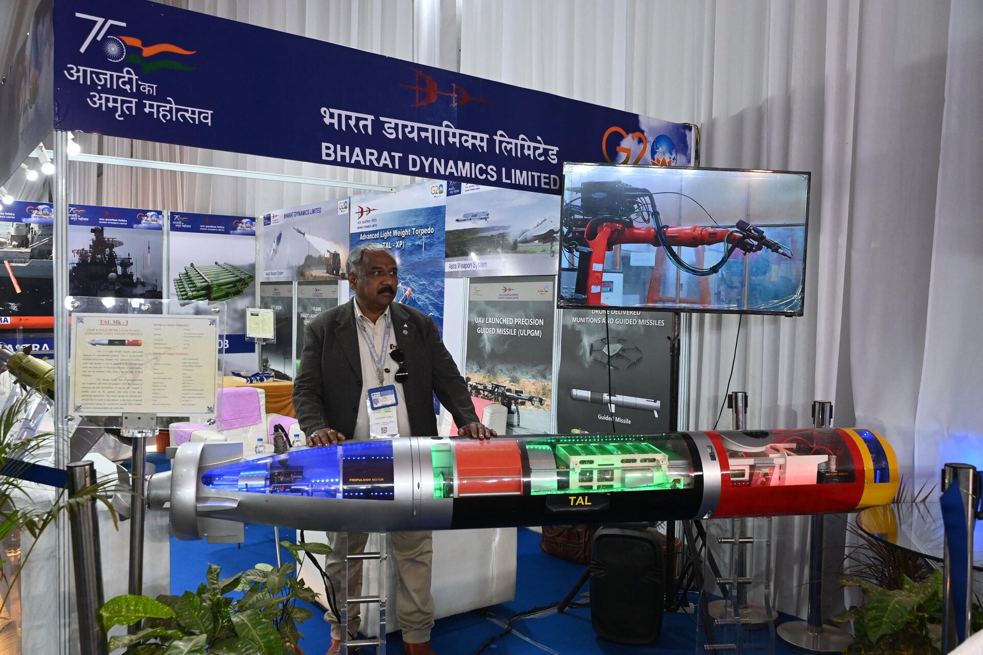 An executive from Bharat Dynamics Limited stands in front of a model of  the TAL MK-1 an anti submarine light weight torpedo at the two-day Andhra Pradesh Global Investors Summit 2023 in Visakhapatnam on March 4, 2023. - Sputnik भारत, 1920, 14.10.2023