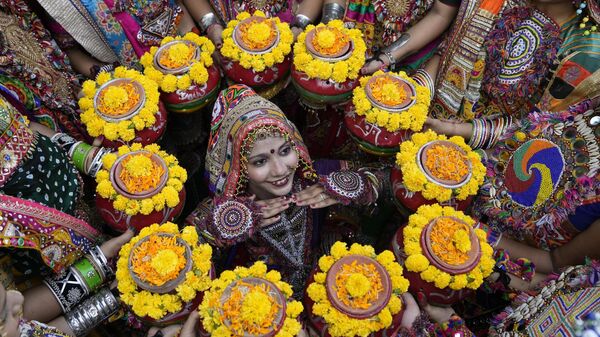 Indians in traditional attire pose for the media as they practice the Garba, a traditional dance of Gujarat state, ahead of Navratri festival in Ahmedabad, India, Monday, Oct. 9, 2023. - Sputnik India