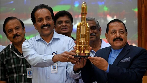 Indian Space Research Organisation (ISRO) chief S. Somanath (2L) and Minister of State for the Ministry of Science and Technology Jitendra Singh (R) hold a model of spacecraft Chandrayaan-3 during a press conference, after its launch from the Satish Dhawan Space Centre in Sriharikota, in India's southern state of Andhra Pradesh on July 14, 2023. - Sputnik India