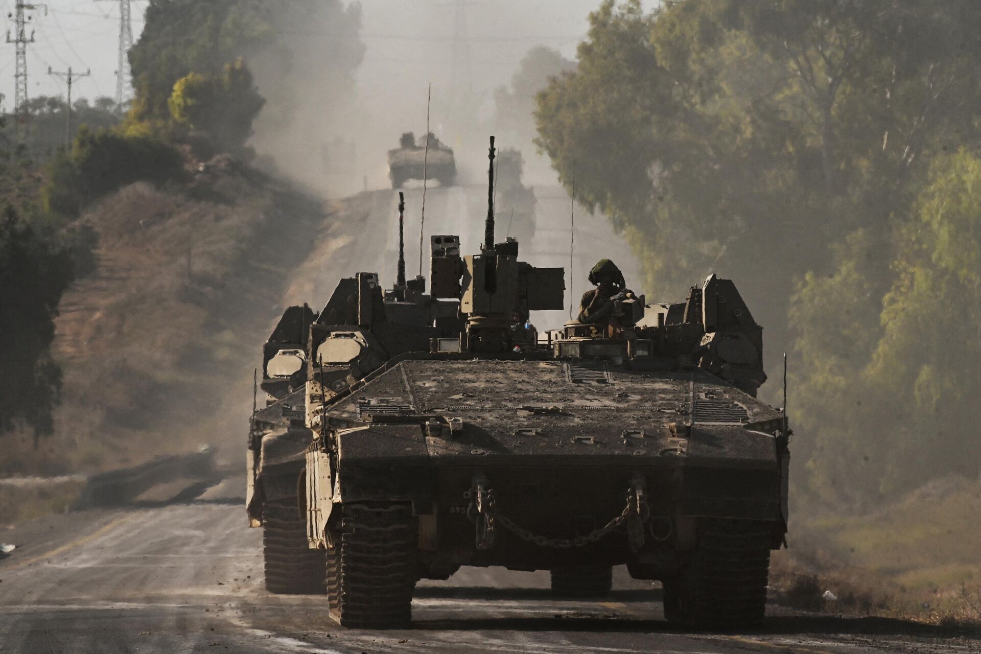 Israeli army armoured vehicles roll towards the border with the Gaza Strip at an undisclosed location in southern Israel on October 15, 2023. - Sputnik India, 1920, 18.10.2023