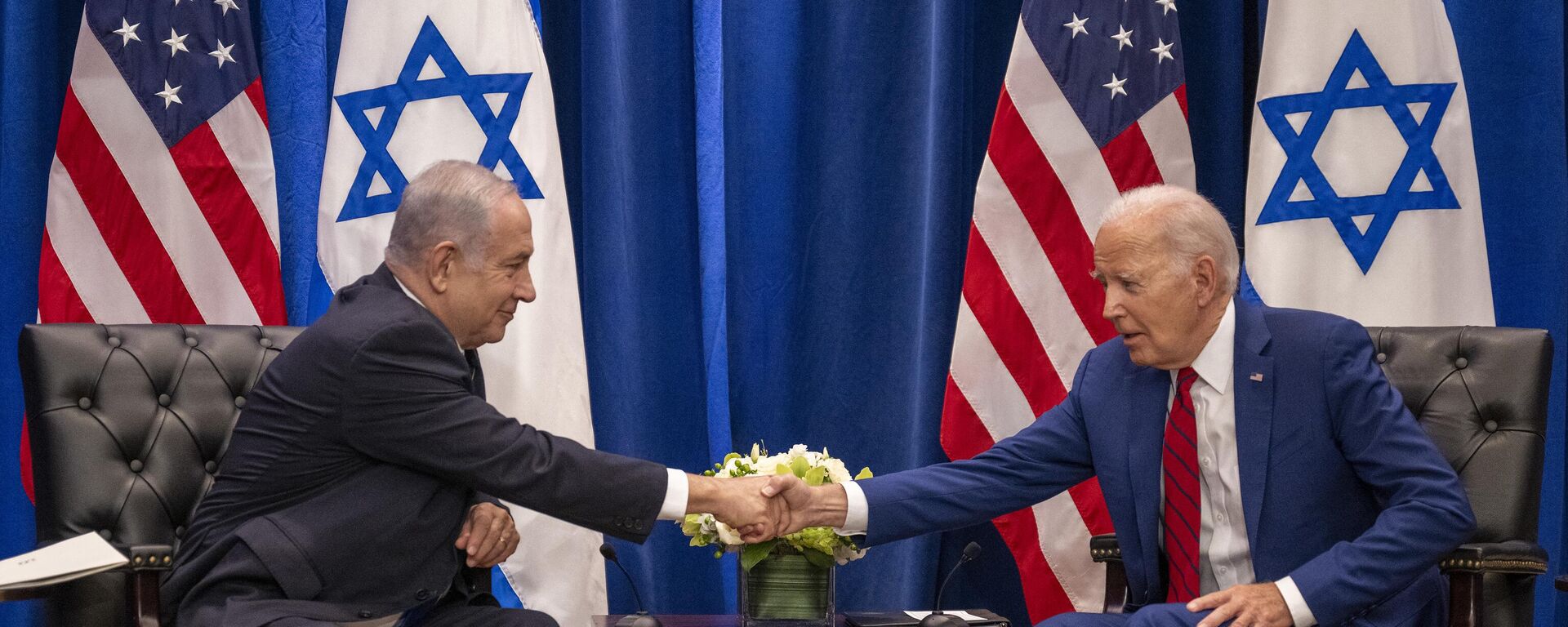 US President Joe Biden shakes hands with Israeli Prime Minister Benjamin Netanyahu as they meet on the sidelines of the 78th United Nations General Assembly in New York City on September 20, 2023.  - Sputnik India, 1920, 17.10.2023