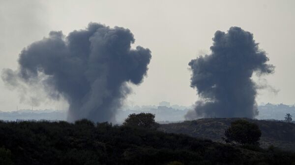 Smoke rises following an Israeli airstrike in the Gaza Strip, as seen from southern Israel - Sputnik भारत