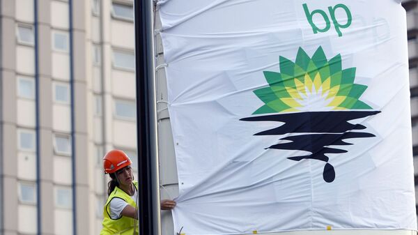 In this Tuesday, July 27, 2010, file photo, a Greenpeace activist puts up a banner as they block off a British Petroleum fuel station in protest as the BP board announce their annual results, in London - Sputnik India