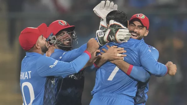 Afghanistan's team members celebrate the wicket of England's Sam Curran with bowler Mohammad Nabi during the ICC Men's Cricket World Cup match between Afghanistan and England in New Delhi, India, Sunday, Oct. 15, 2023.  - Sputnik भारत