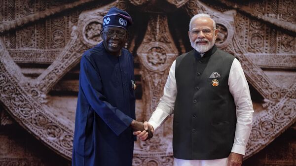 Indian Prime Minister Narendra Modi shakes hand with Nigeria President Bola Ahmed Tinubu  - Sputnik India