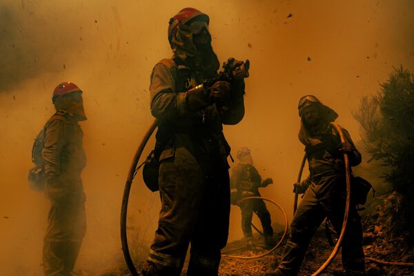 &quot;Fire and Ashes&quot;, 3rd place, Adra Pallon (Spain). Top News, series.Several firemen working directly against the advancing fire. After several days the fire is still out of control.  SPAIN. Vilarbacú. O Courel. Lugo. Thursday, 21 July 2022. - Sputnik India