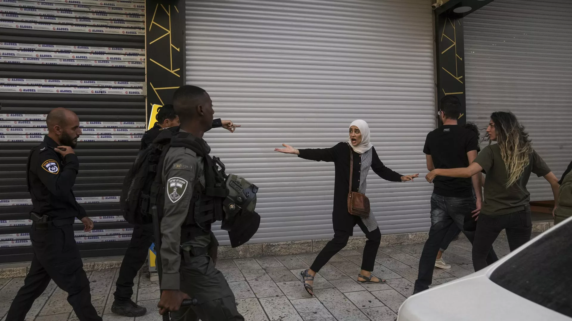 Palestinian demonstrators argue with Israeli police during a protest against the Israeli military raid on the militant stronghold of the Jenin refugee camp