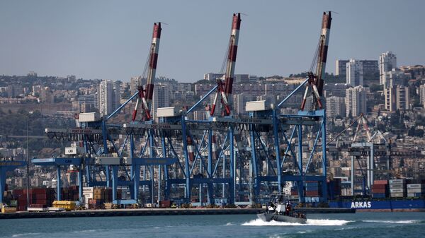 An Israeli military boat makes its way past cranes along the docks of the port of the northern city of Haifa, on June 24, 2021 - Sputnik India
