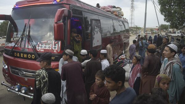 In this photo taken on September 21, 2023, Afghans board a bus heading from Karachi to Afghanistan. Afghans have poured into Pakistan in their millions during decades of successive wars, many living in aid camps with restricted access to education, healthcare and employment. - Sputnik India