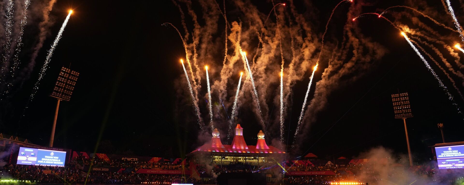 Himachal Pradesh Cricket Association stadium is lit up with lights and fireworks after the ICC Men's Cricket World Cup match between Australia and New Zealand in Dharamshala, India, Saturday, Oct. 28, 2023.  - Sputnik भारत, 1920, 01.11.2023