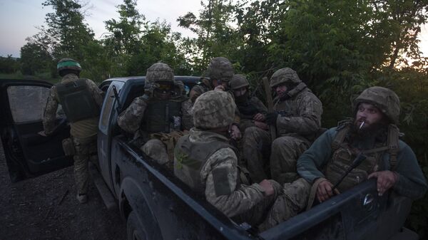 Ukrainian soldiers sit in a pickup truck at their position on the frontline close to Bakhmut, - Sputnik भारत