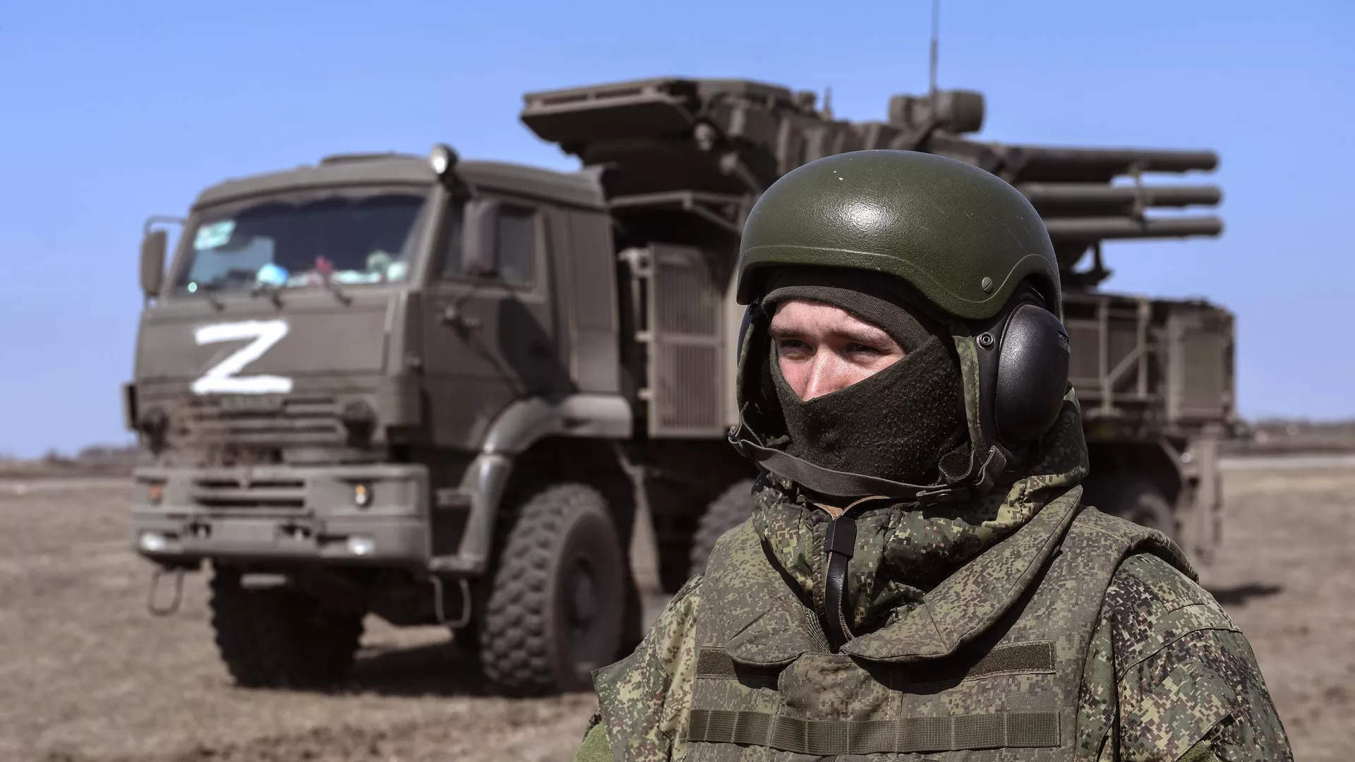 A Russian serviceman stands in front of a Pantsir-S1 air defence missile system during the Russian military operation in Ukraine