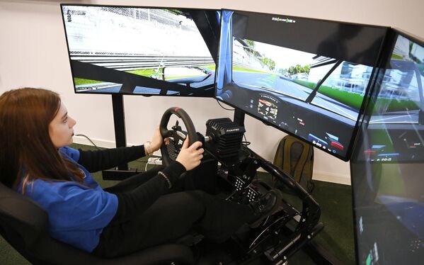 RUSSIA EXPO visitor drives a car on a simulator - Sputnik India