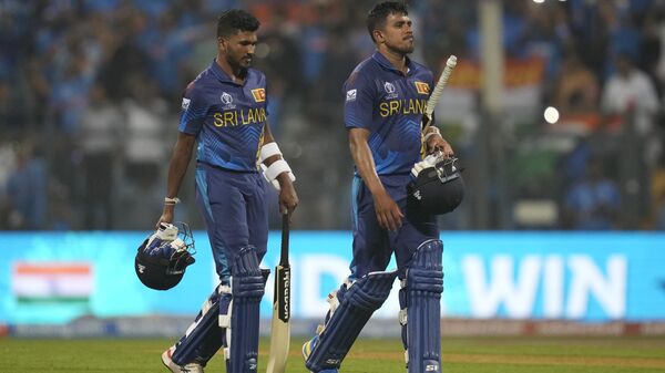 Sri Lanka's Dilshan Madushanka, left and Maheesh Theekshana walks off the field after losing the ICC Men's Cricket World Cup match against India in Mumbai, India, Thursday, Nov. 2, 2023 - Sputnik भारत