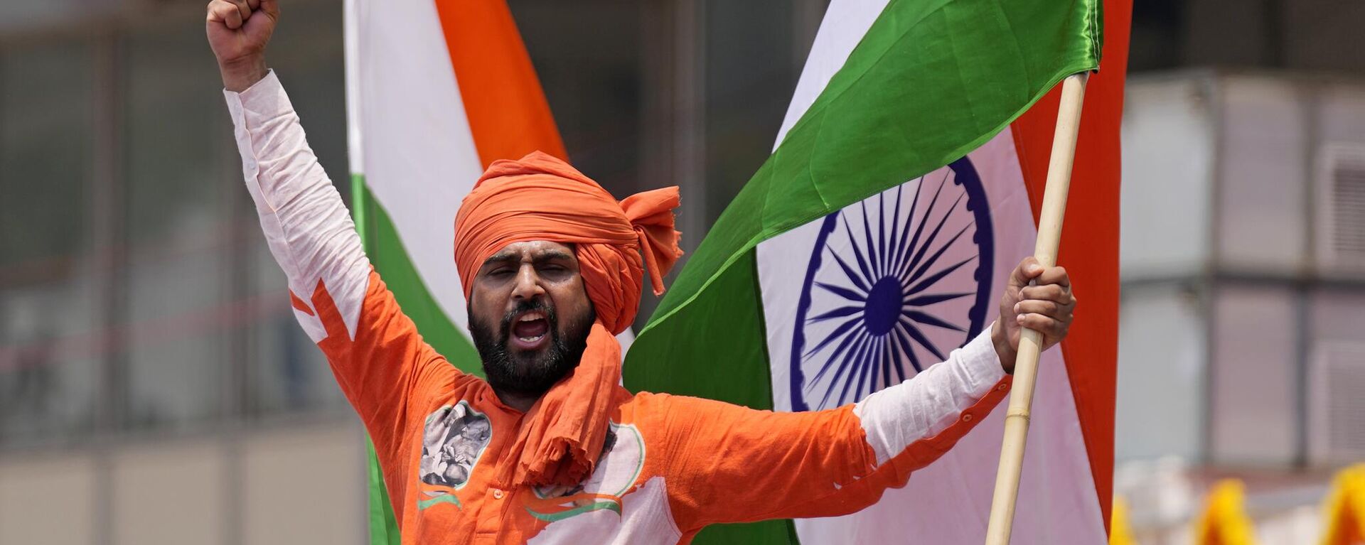 A supporter of Congress party shouts slogans after party leader Siddaramaiah was sworn in as Chief Minister of Karnataka state in Bengaluru, India, Saturday, May 20, 2023. - Sputnik India, 1920, 07.11.2023