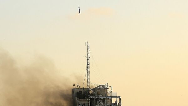 An air guided bomb can be seen hitting Al-Sharouk tower as it collapses during an Israeli air strike - Sputnik India